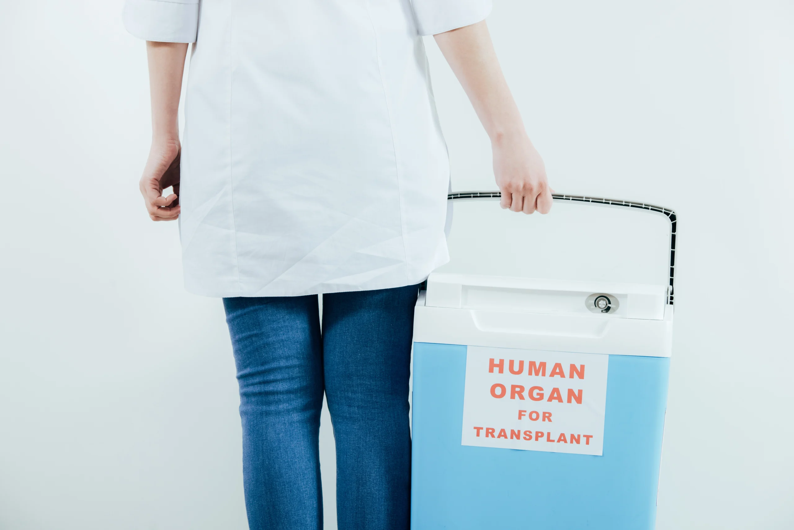 nurse holding a cooler with human organs in it.