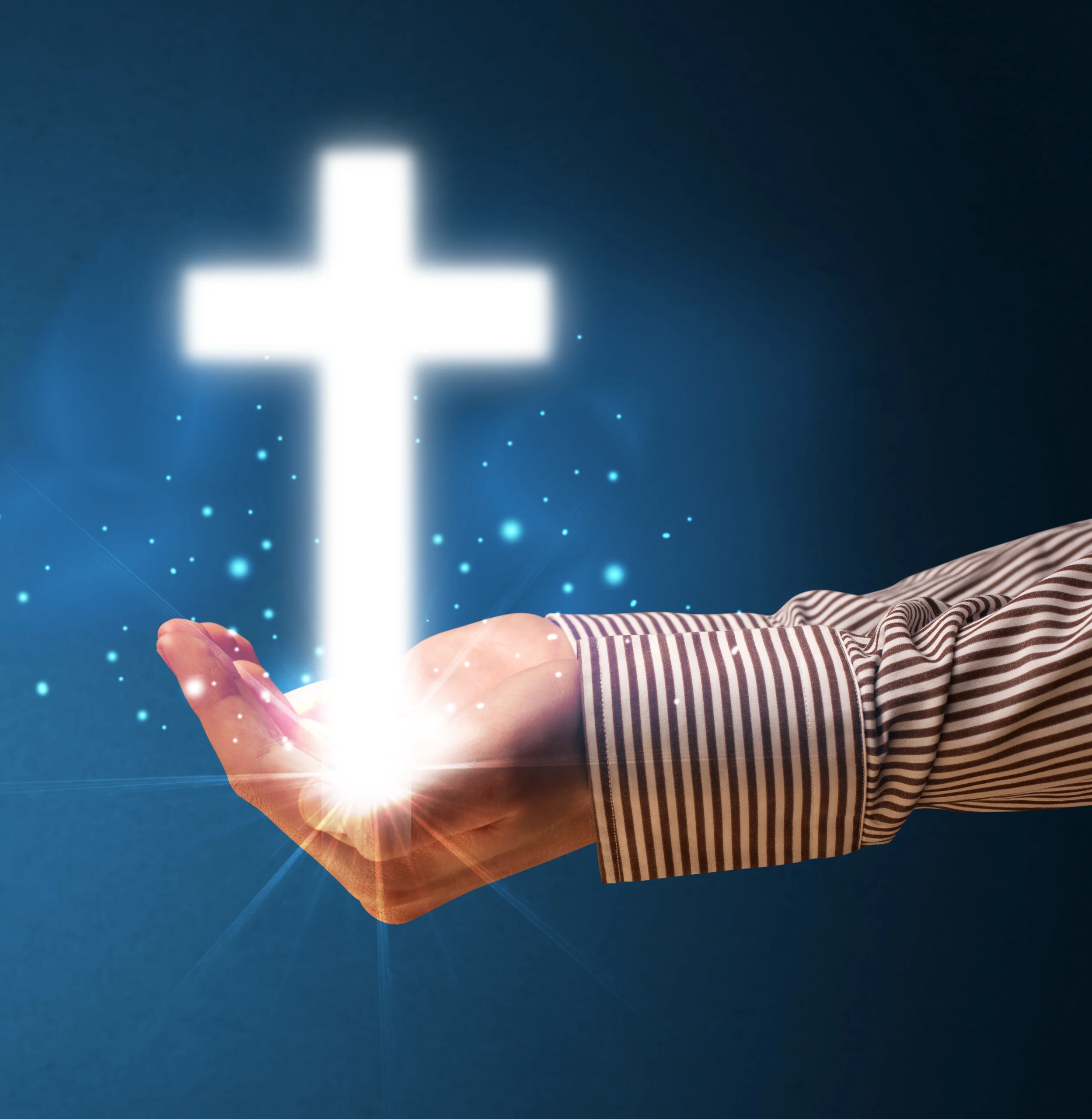 hand holding a glowing cross