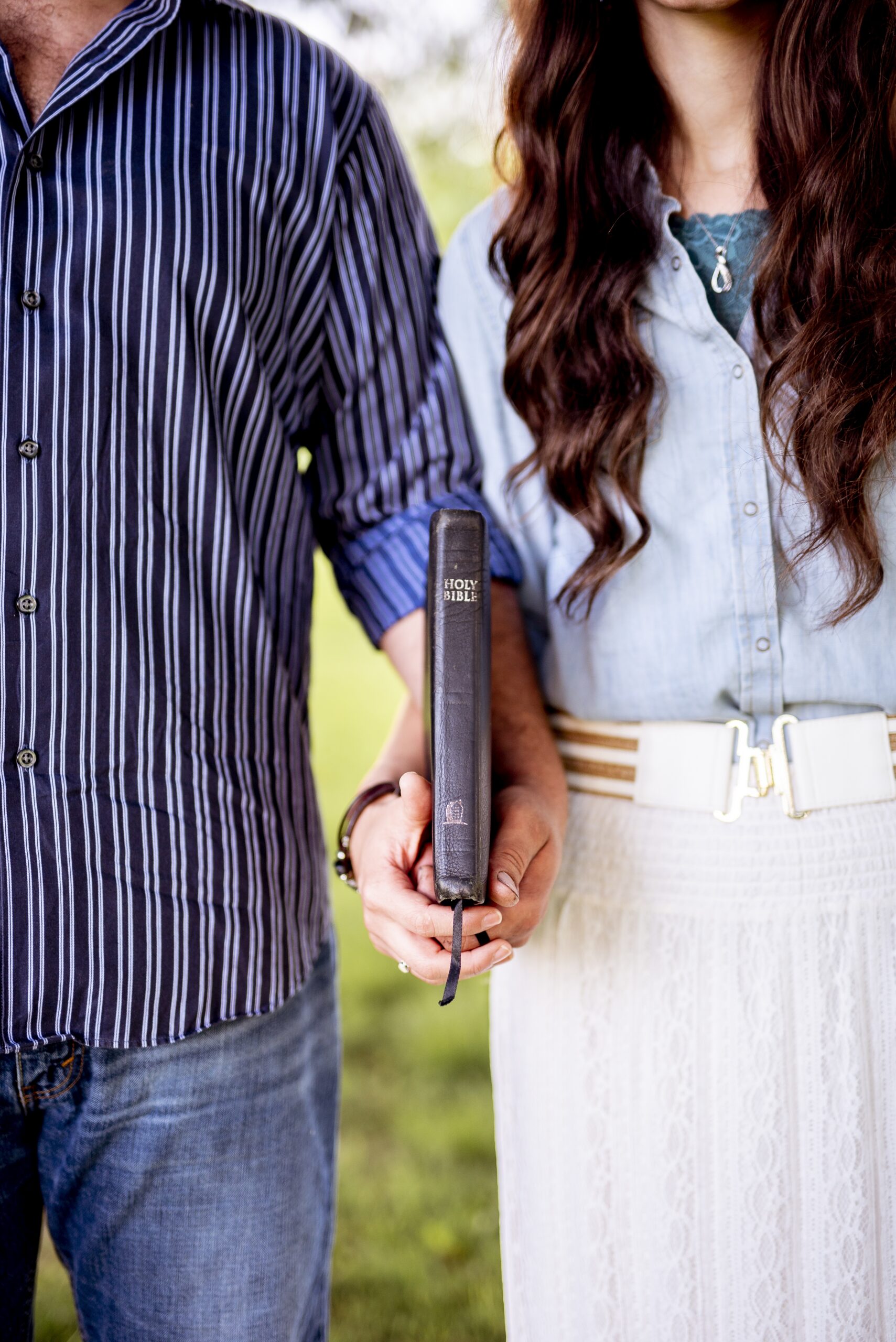 couple holding a bible between them