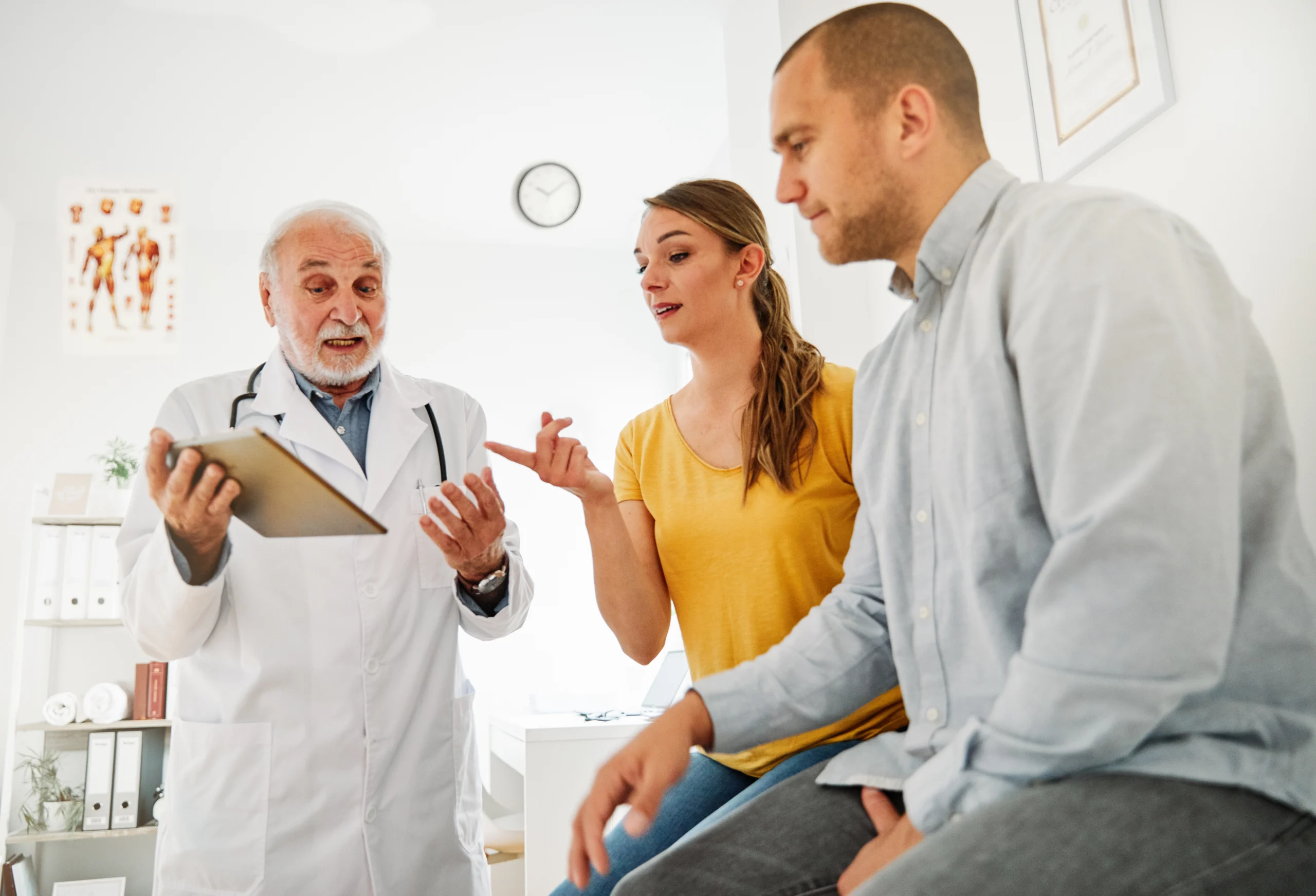 doctor discussing health with patient and her husband