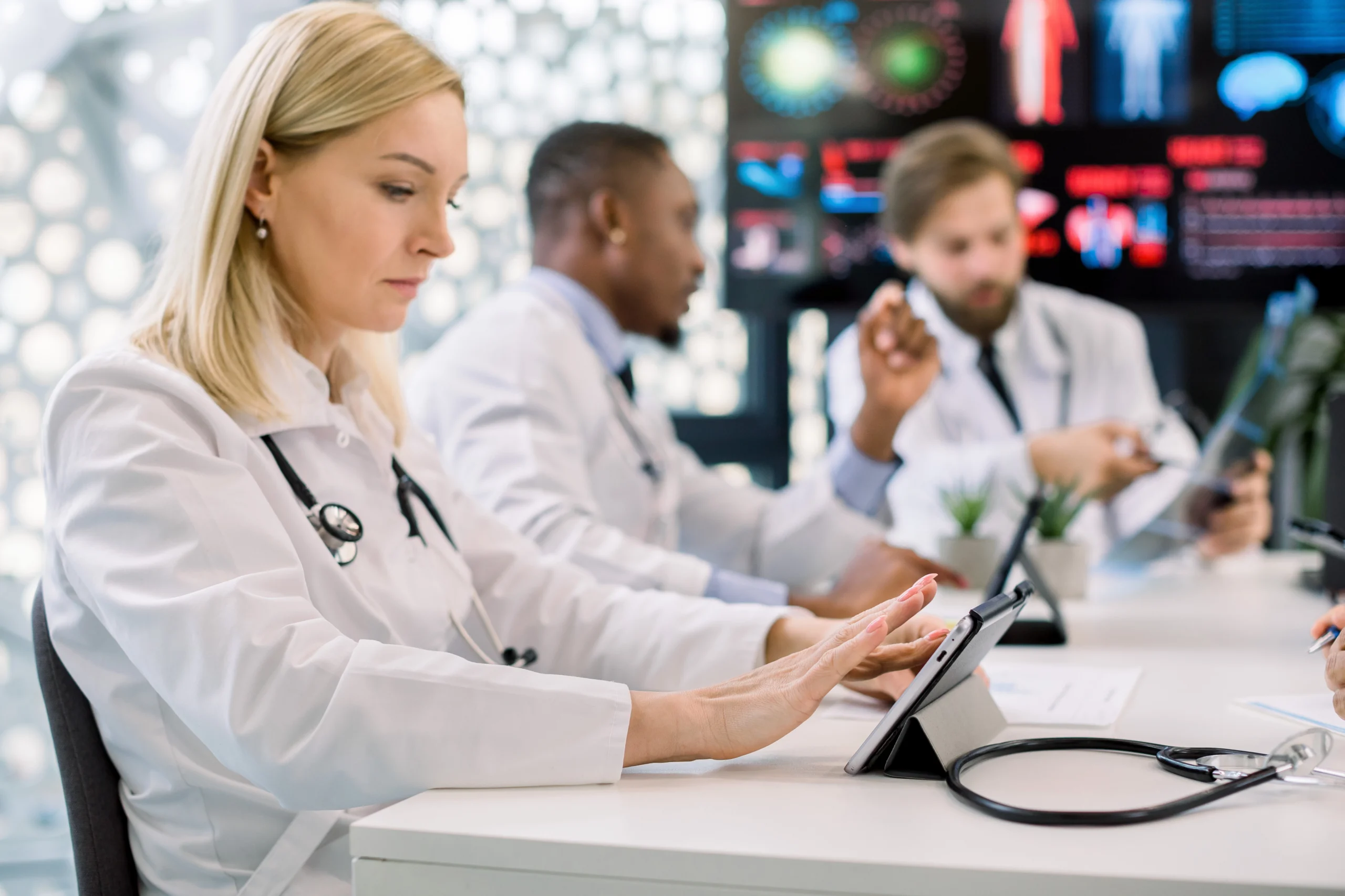 doctors collaborating in a meeting room using technology