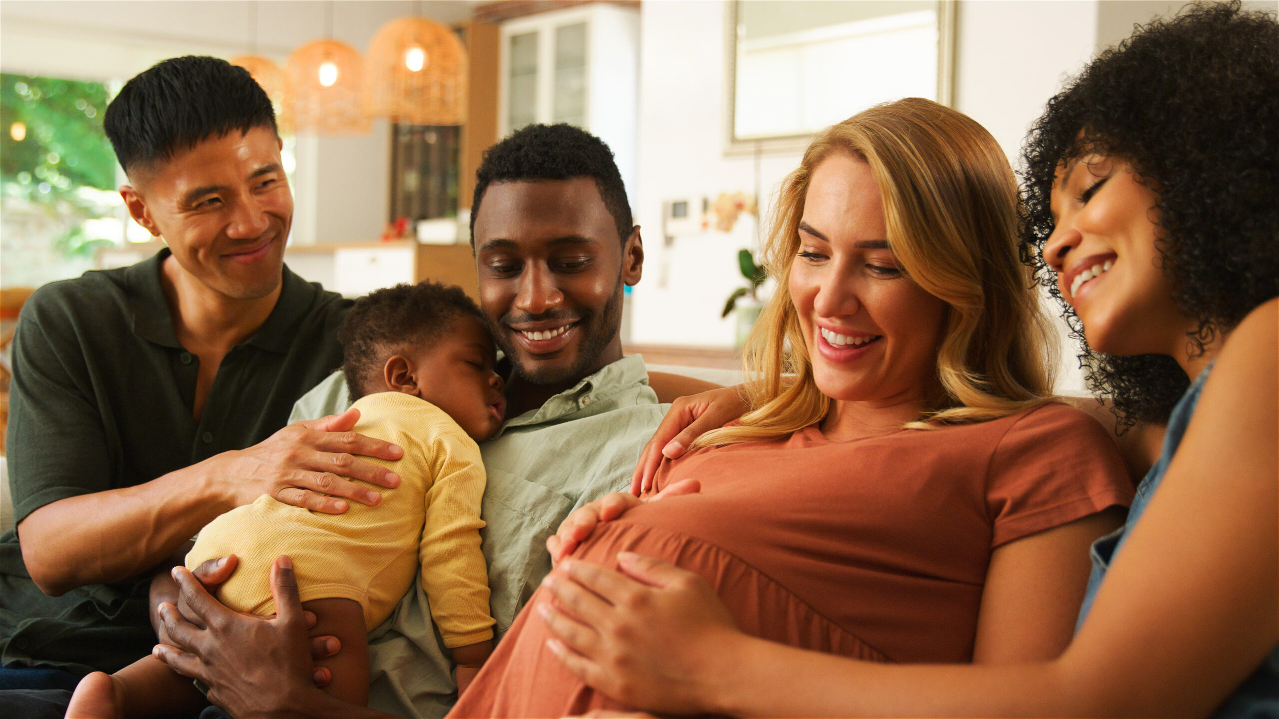 family surrounding pregnant woman