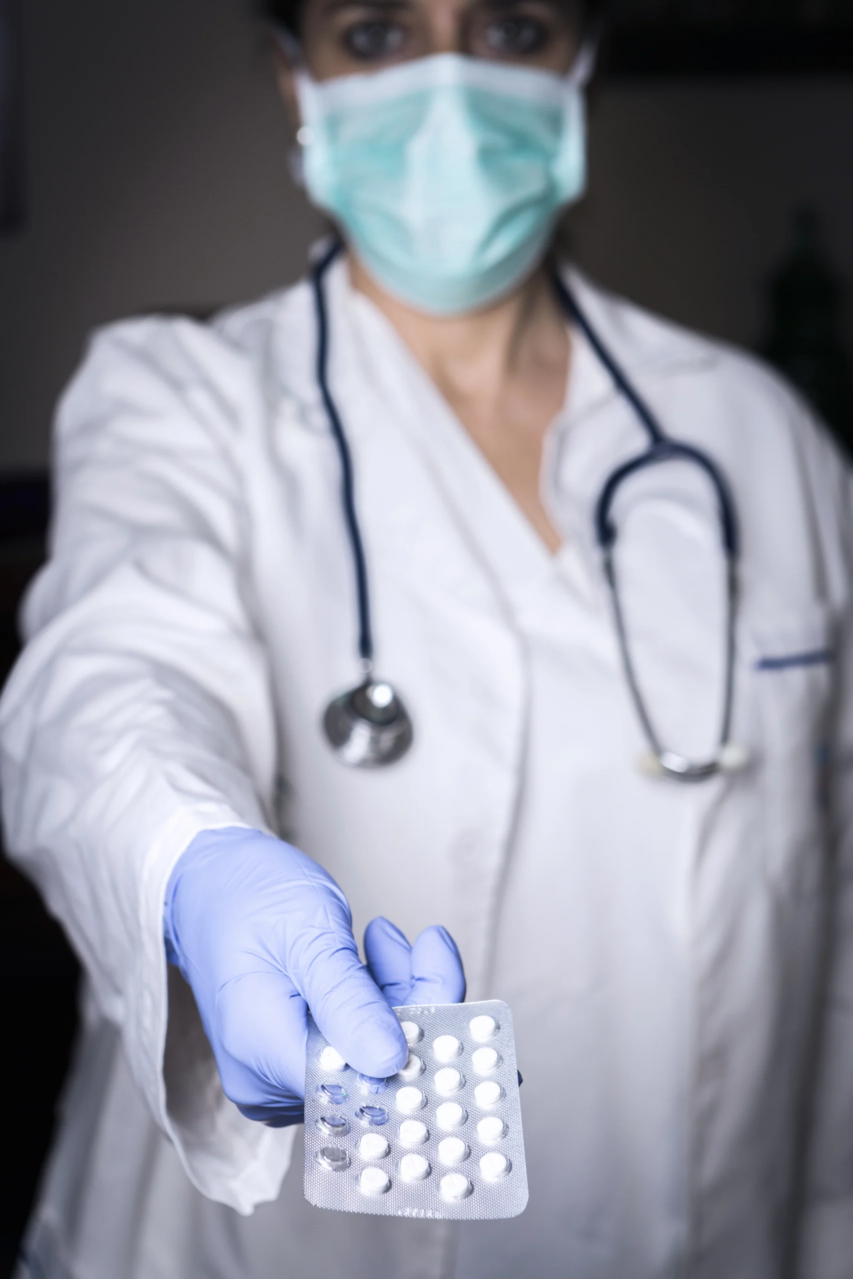 doctor handing patient birth control pack