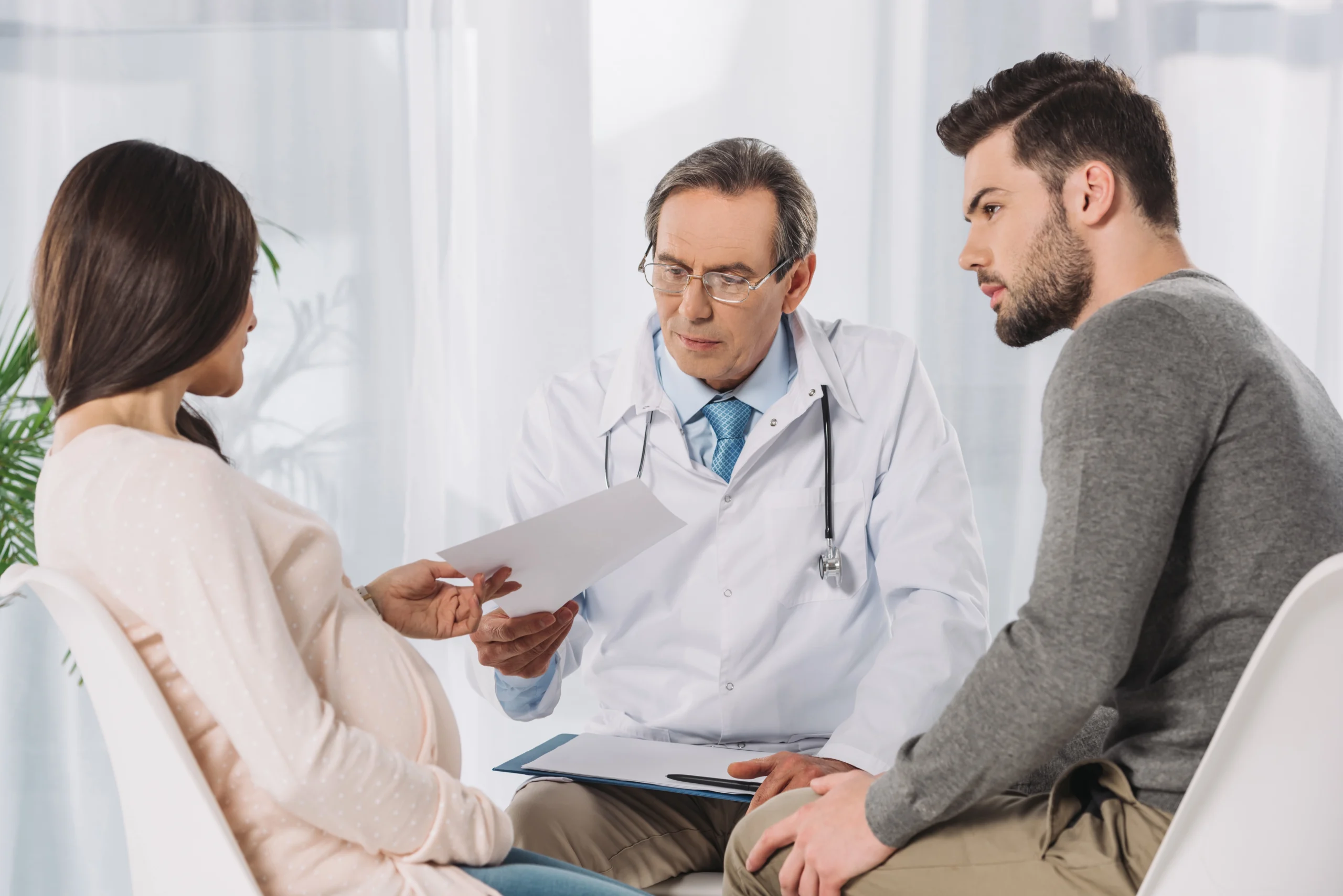 pregnant couple consulting with a doctor
