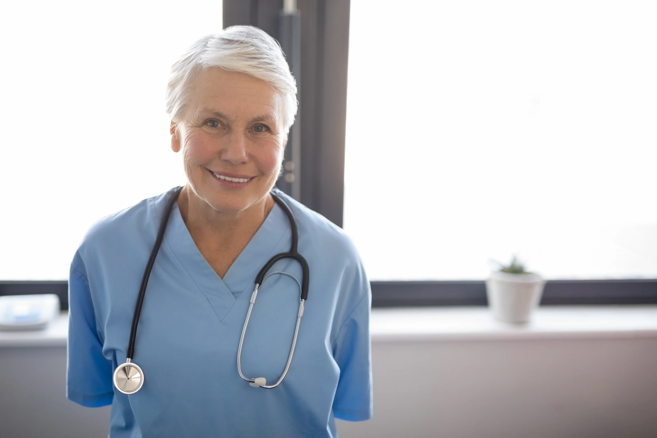 smiling older nurse with stethoscope