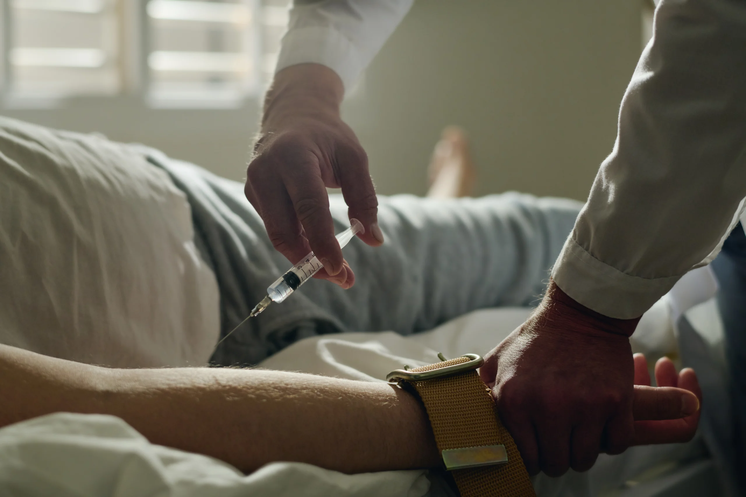 doctor injecting medicine into a patient